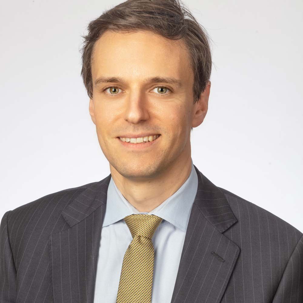 Mr James E. Neffendorf professional headshot in a suit smiling